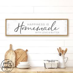 a wooden sign that says happiness is homemade with love and butter on top of a table