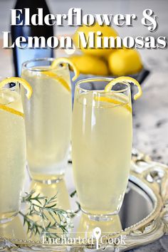 two glasses of elderflower and lemon mimosas on a tray with lemons in the background