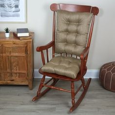 a wooden rocking chair sitting next to a dresser