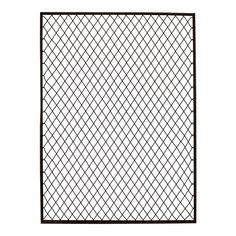 a black and white photo of a fence with squares on the top, in front of a