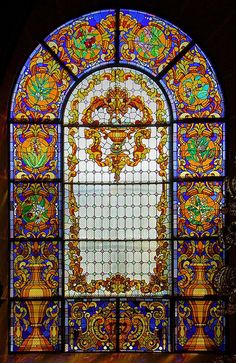 an ornate stained glass window in a building