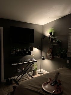 a bedroom with a guitar, keyboard and plant on the bed in front of it