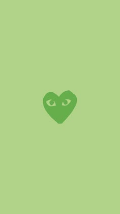 a green heart with two eyes in the middle on a light green wallpaper background