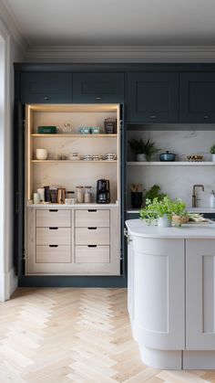 a kitchen with blue cabinets and white counter tops is pictured in this image from the inside