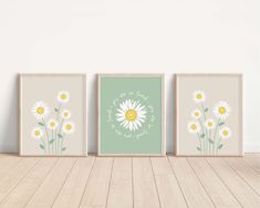 three framed art prints with daisies on them