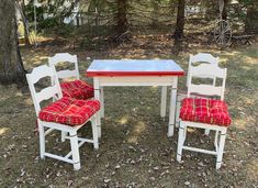 two chairs and a table in the grass