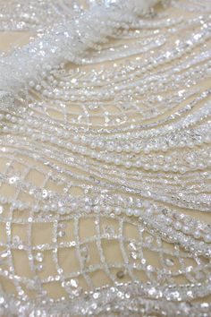 Beaded Embroidery Floral Lace Fabric With Sequins Heavy Beading Bridal Lace Fabric 51 inches Width For Wedding Dress Couture Lace Fabric This lace has an amazing look and is really very heavy. It is perfect the the most unique bridal dresses. Width about: 51inch (130Centimeters) Length : 91 Centimeters/ 1Yard Material: Beads, Sequin,Pearls, Metallic Thread Colors: Off White Price is set for one yard. You will receive the fabric in one continuous piece if you purchase more than 1 yard. Our lace p White Beaded Sequin Fabric For Wedding, White Pearl Embroidered Fabric For Banquet, Silver Sequin Fabric With Pearl Embroidery For Wedding, Silver Beaded Embroidered Fabric For Wedding, Beaded Sequin Fabric For Wedding, White Beaded Embroidered Fabric For Wedding, White Embellished Embroidered Fabric For Banquet, White Beaded Wedding Dress For Party, Elegant Beaded Sequin Fabric For Wedding