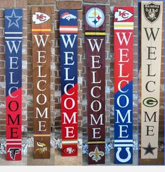 several wooden signs are hanging on a brick wall with the words welcome, welcome, welcome and welcome