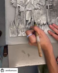 a person is drawing on a piece of paper