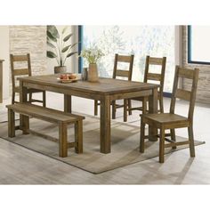 a dining room table with four chairs and a bench