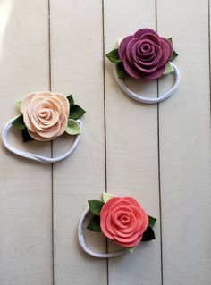 three different types of paper flowers sitting on top of each other with the words mulbberry, oats and coral