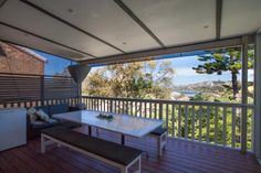 a table and bench on a wooden deck