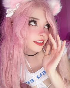 a woman with pink hair and cat ears