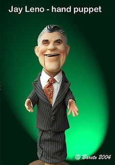 a statue of a man in a suit and tie with the caption jay leno - hand puppett