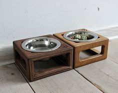 two wooden dog bowls with metal dishes on the top one is empty and the other has food in it