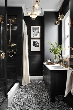 a black and white bathroom with gold fixtures, chandelier, shower curtain, rug