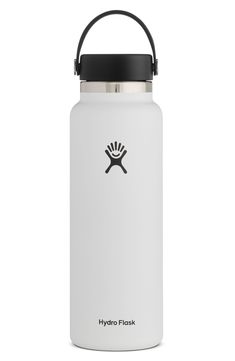 the hydro flask water bottle in white with black lid and handle is shown against a white background