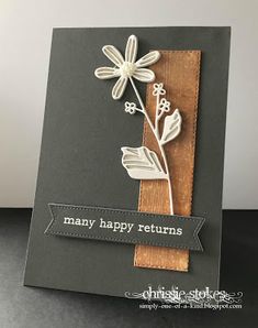 a close up of a card with a flower on the front and an arrow on the back