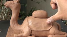 a clay camel sitting on top of a table