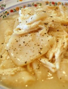 a close up of food on a plate with gravy and some seasoning