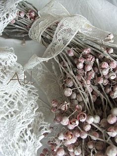 some white lace and flowers on a table