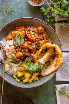 a bowl filled with rice, meat and vegetables