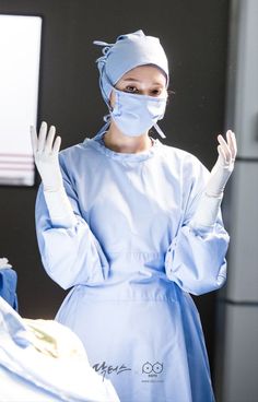 a woman wearing a surgical mask and gloves