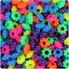 many different colored plastic beads with holes in them