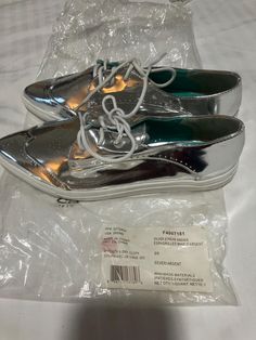 This is a silver canvas sneaker Size 8 Made in China .  Man made material  wipe with water for cleaning. Canvas Sneakers, Loafers For Women, Canvas Shoes, Loafer Flats, Flat Shoes Women, Shoes Flats, China, Loafers, Slip On