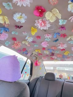 the interior of a car decorated with colorful paper flowers and butterflies on it's ceiling