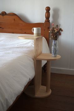 a bed with a wooden headboard and night stand next to it on the floor