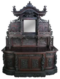 an ornate wooden cabinet with mirror on top