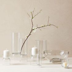 a white table topped with vases and candles