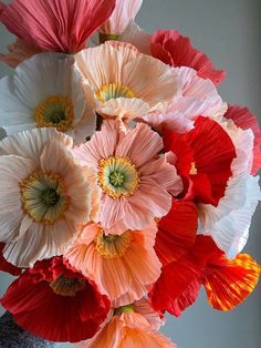 a vase filled with lots of different colored flowers