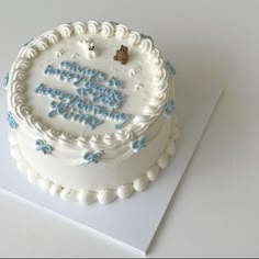 a white cake with blue frosting that says, happy birthday to the one who came first