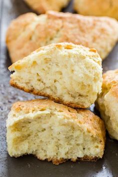 several pieces of biscuit sitting on top of a baking pan next to each other