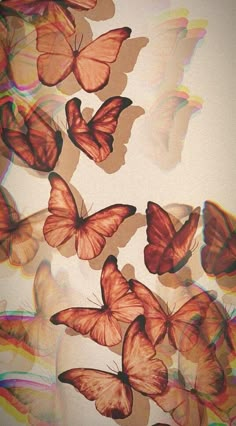 many butterflies are flying in the air with colored lines on them and one is upside down