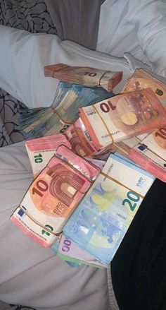 several different bills laid out on a bed