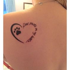 the back of a woman's shoulder with a dog paw and heart tattoo on it