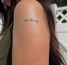 a woman with a tattoo on her arm that says, love is in the air