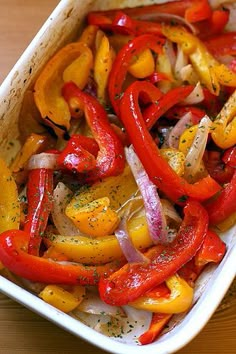 a casserole dish filled with peppers and onions