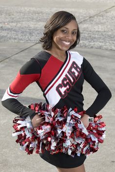 a cheerleader posing for the camera with her red and white pom - poms