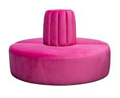 a large pink round couch sitting on top of a white floor