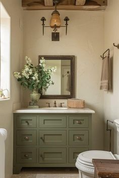 a bathroom with a toilet, sink and mirror