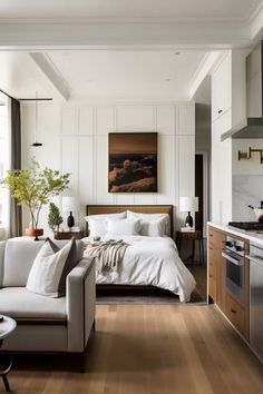 a living room filled with furniture next to a kitchen