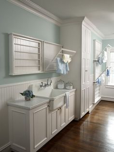 an image of a bathroom with white cabinets and green towels on the rack above the sink