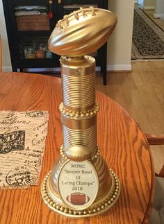 a football trophy sitting on top of a wooden table