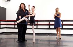 three women are standing in a dance studio