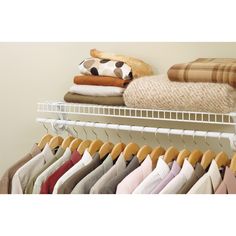 a rack with clothes and pillows on it