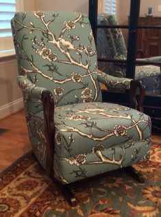 a blue chair sitting on top of a wooden floor